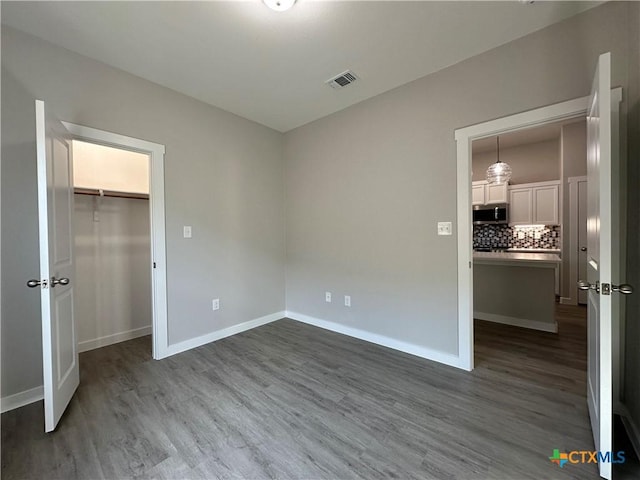 unfurnished bedroom with hardwood / wood-style floors