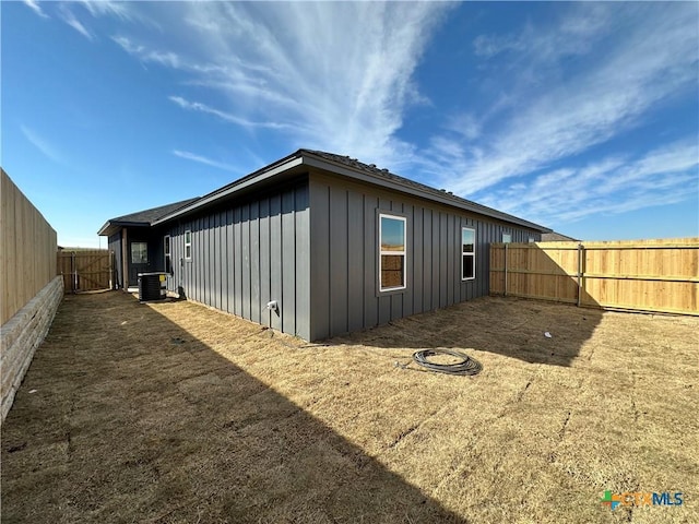 view of side of home with central air condition unit