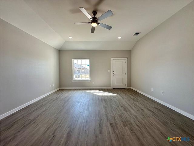 spare room with lofted ceiling, dark hardwood / wood-style floors, and ceiling fan