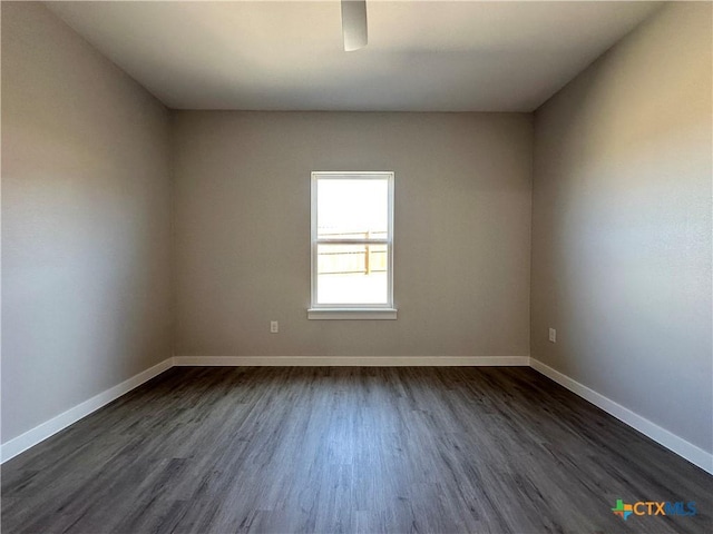 spare room with dark wood-type flooring and ceiling fan