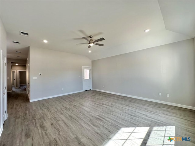 empty room featuring vaulted ceiling, ceiling fan, and light wood-type flooring