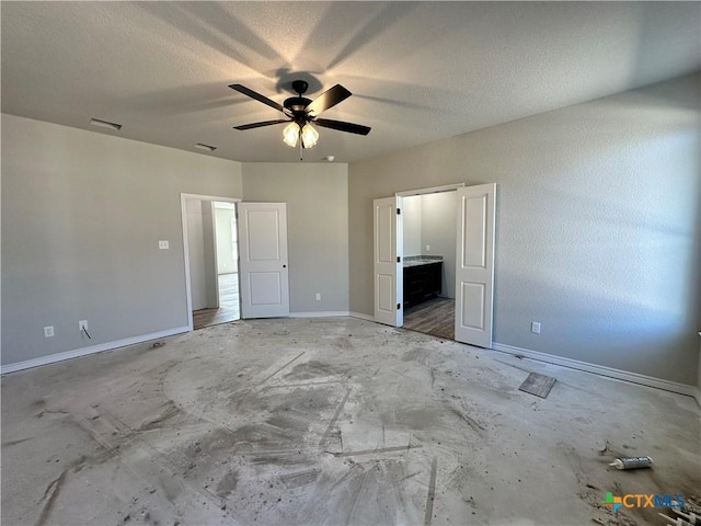 unfurnished bedroom with connected bathroom, a textured ceiling, and ceiling fan