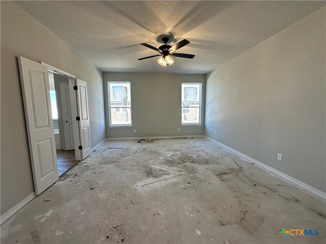 unfurnished bedroom with ceiling fan and a textured ceiling