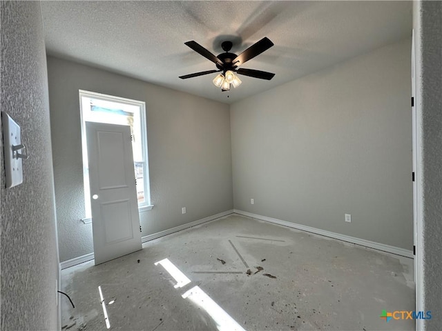 empty room featuring ceiling fan and a textured ceiling