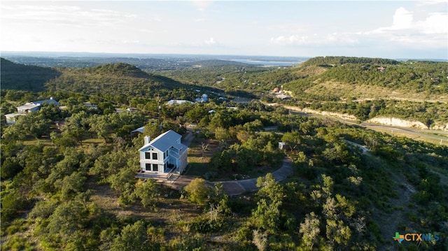 461 Naked Indian Trl, New Braunfels, TX 78132 - aerial view of property and surrounding area featuring a heavily wooded area