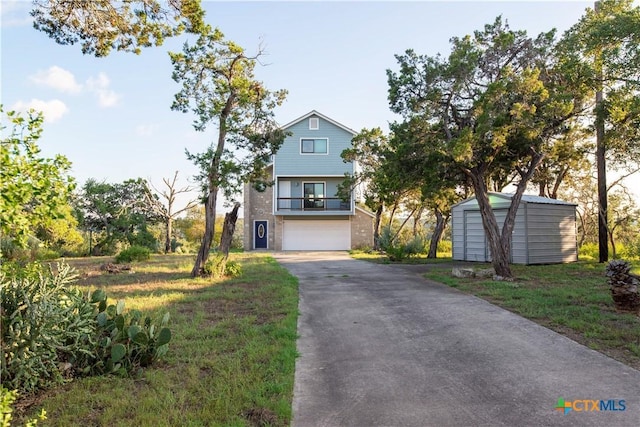 461 Naked Indian Trl, New Braunfels, TX 78132 - view of front of property with a storage shed, driveway, brick siding, an outdoor structure, and a balcony