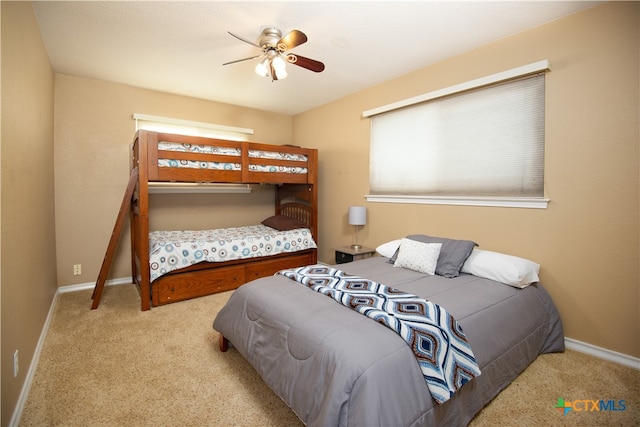 bedroom with light colored carpet and ceiling fan