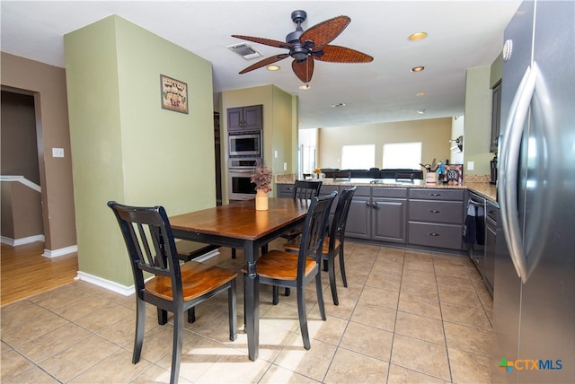 tiled dining room with ceiling fan