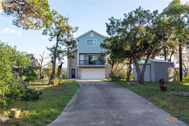 461 Naked Indian Trl, New Braunfels, TX 78132 - view of front of property featuring a storage unit, asphalt driveway, an attached garage, an outdoor structure, and a balcony
