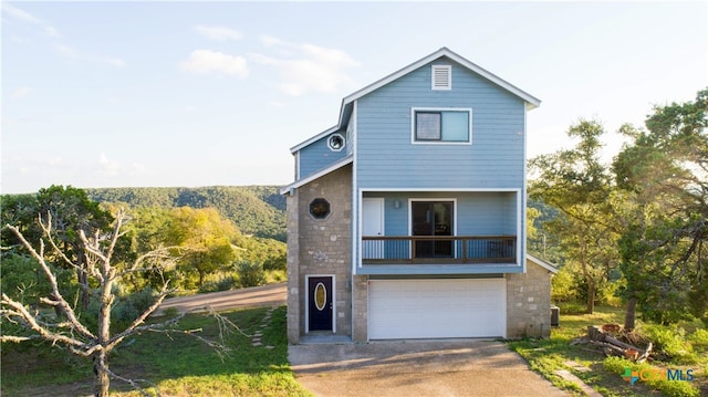 view of front property featuring a balcony and a garage