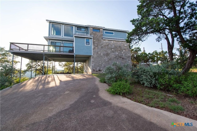 461 Naked Indian Trl, New Braunfels, TX 78132 - view of front of property featuring asphalt driveway, stone siding, and a carport