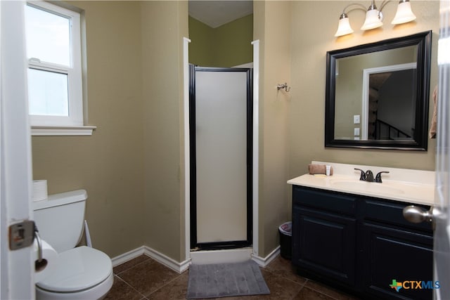 bathroom featuring walk in shower, vanity, and tile patterned floors