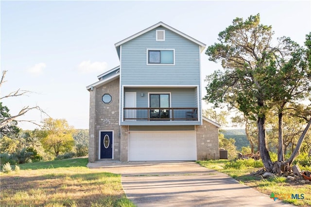 461 Naked Indian Trl, New Braunfels, TX 78132 - view of front facade featuring concrete driveway, a balcony, central AC unit, a garage, and stone siding