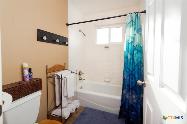 bathroom with toilet and shower / bath combination with curtain