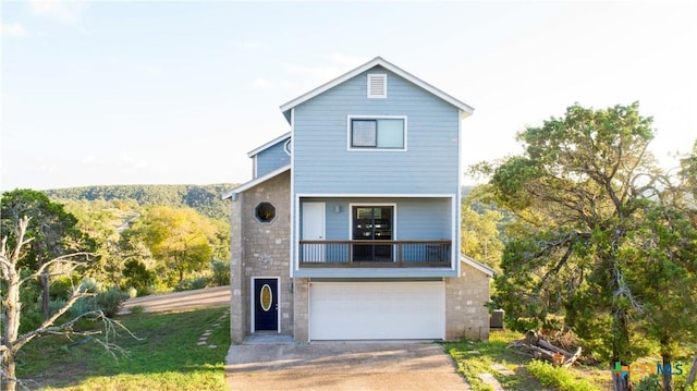 461 Naked Indian Trl, New Braunfels, TX 78132 - view of front of home with driveway, a garage, a balcony, and stone siding