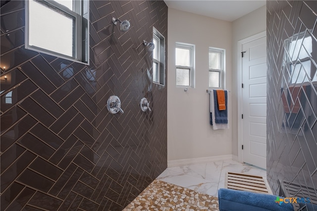 bathroom with tiled shower