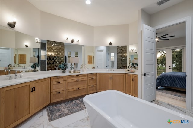 bathroom featuring a tub, vanity, ceiling fan, and a high ceiling