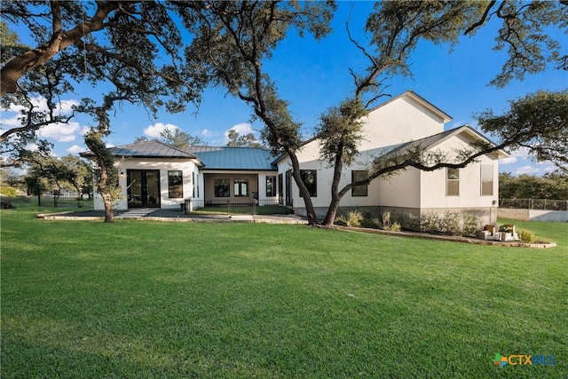 rear view of house featuring a yard