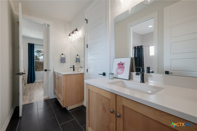 bathroom featuring tile patterned flooring and vanity