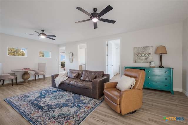 living room featuring hardwood / wood-style floors and ceiling fan