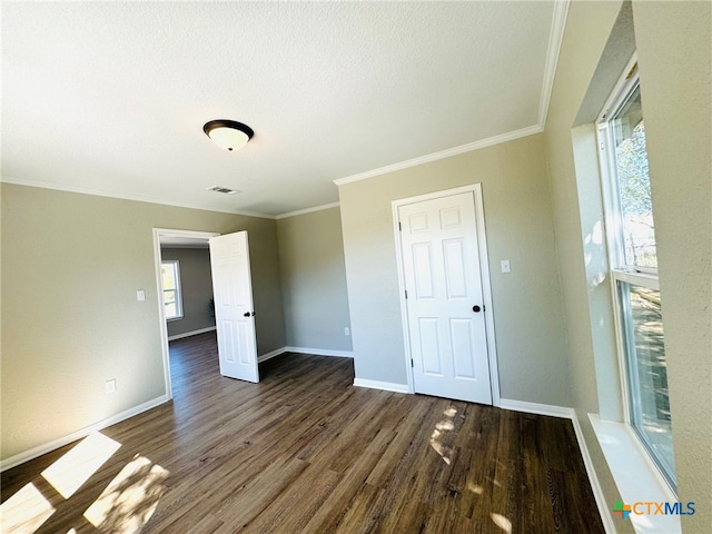 unfurnished room with dark hardwood / wood-style flooring and crown molding