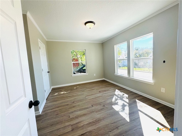 unfurnished room with dark hardwood / wood-style floors, a textured ceiling, and crown molding