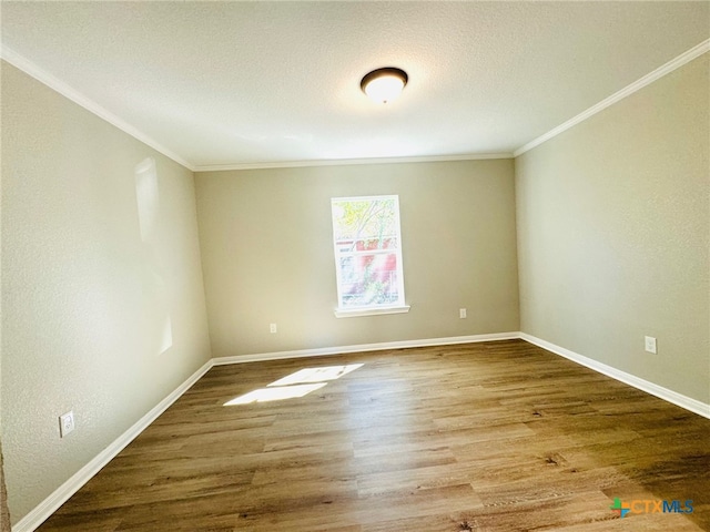 unfurnished room featuring a textured ceiling, wood-type flooring, and crown molding