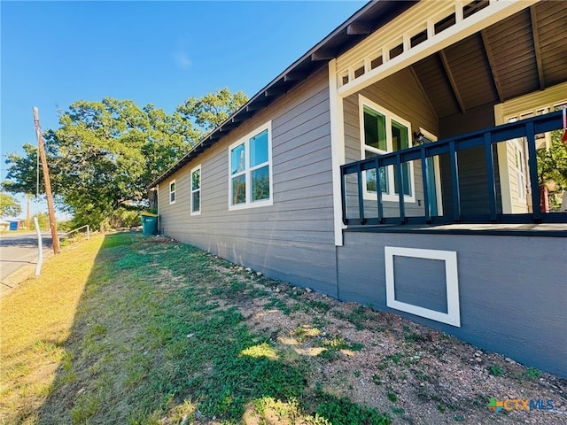 view of side of home featuring a yard