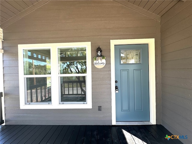 view of exterior entry with a deck