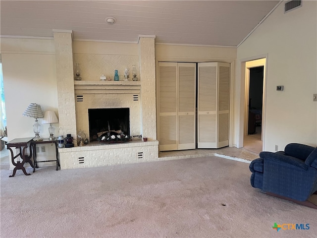 living room featuring a fireplace, vaulted ceiling, ornamental molding, and carpet floors