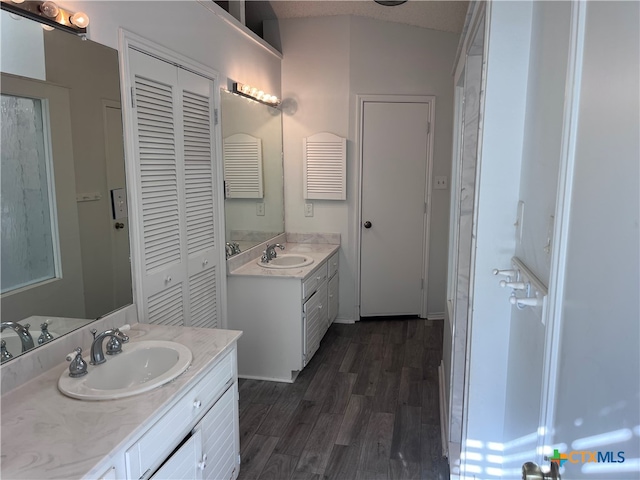 bathroom featuring vanity, wood-type flooring, and a textured ceiling