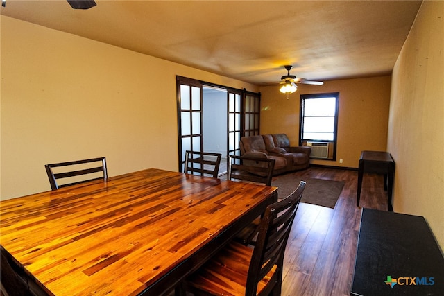 dining room featuring cooling unit, wood-type flooring, and ceiling fan