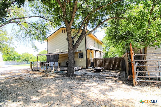 rear view of property featuring a deck