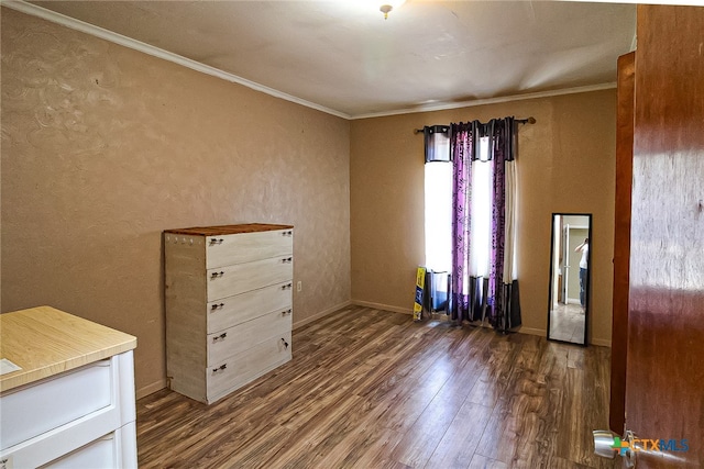 unfurnished room featuring ornamental molding and dark hardwood / wood-style floors