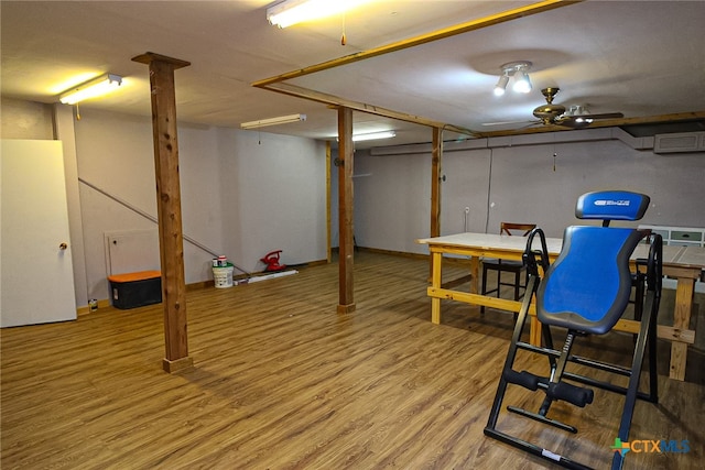 basement featuring hardwood / wood-style flooring and ceiling fan