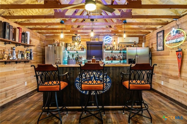 29720 Twin Creeks Dr, Bulverde, TX 78163 - indoor dry bar with freestanding refrigerator, wood walls, stainless steel refrigerator with ice dispenser, dark wood finished floors, and beamed ceiling