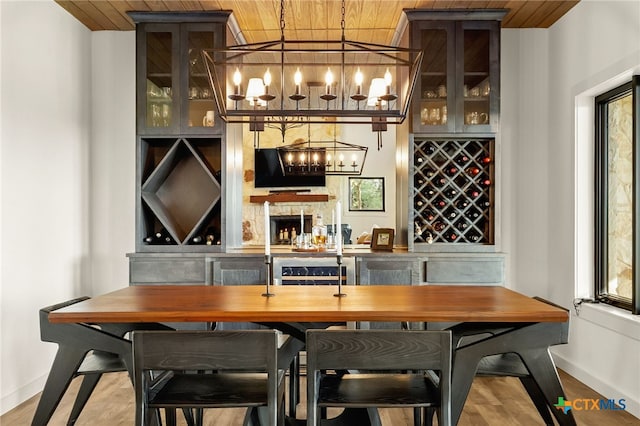 29720 Twin Creeks Dr, Bulverde, TX 78163 - indoor bar featuring wooden ceiling, baseboards, a chandelier, wood finished floors, and decorative light fixtures