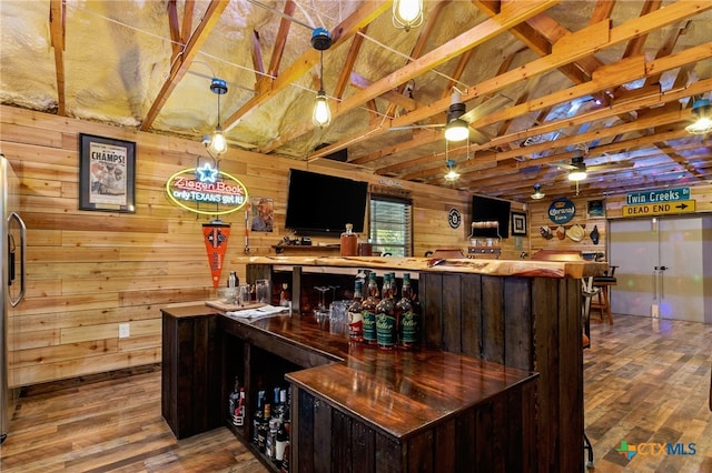 29720 Twin Creeks Dr, Bulverde, TX 78163 - indoor dry bar featuring wooden walls, wood finished floors, ceiling fan, lofted ceiling, and hanging light fixtures