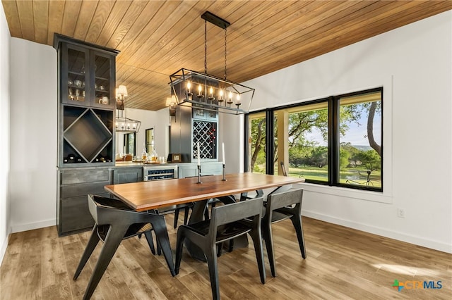 29720 Twin Creeks Dr, Bulverde, TX 78163 - dining space with wooden ceiling, a chandelier, baseboards, light wood-style flooring, and wine cooler