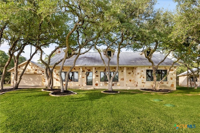 29720 Twin Creeks Dr, Bulverde, TX 78163 - rear view of house featuring a yard, metal roof, and stone siding