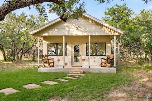 29720 Twin Creeks Dr, Bulverde, TX 78163 - rear view of house featuring a yard and stone siding