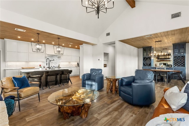 29720 Twin Creeks Dr, Bulverde, TX 78163 - living room featuring a chandelier, wood finished floors, beam ceiling, high vaulted ceiling, and recessed lighting