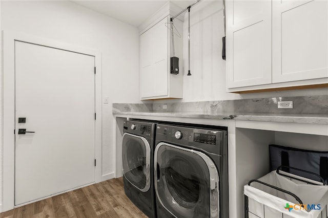 29720 Twin Creeks Dr, Bulverde, TX 78163 - washroom with cabinet space, washing machine and dryer, and wood finished floors