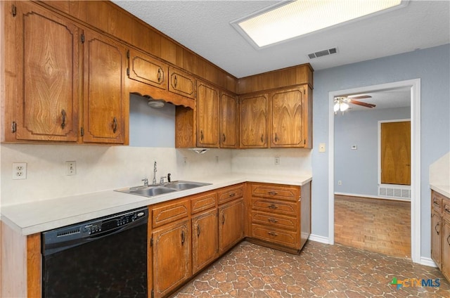 1606 Cedar Oaks Ln, Harker Heights, TX 76548 - kitchen with dishwasher, brown cabinetry, light countertops, and a textured ceiling
