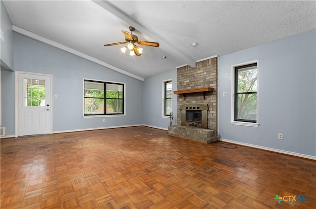1606 Cedar Oaks Ln, Harker Heights, TX 76548 - unfurnished living room with ceiling fan, healthy amount of natural light, a textured ceiling, and a fireplace