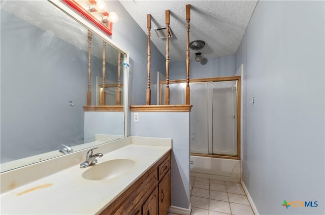 1606 Cedar Oaks Ln, Harker Heights, TX 76548 - bathroom featuring vanity, enclosed tub / shower combo, tile patterned floors, and a textured ceiling