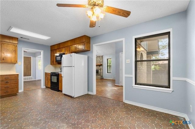 1606 Cedar Oaks Ln, Harker Heights, TX 76548 - kitchen featuring black appliances, a ceiling fan, brown cabinetry, a textured ceiling, and dark stone finish floors