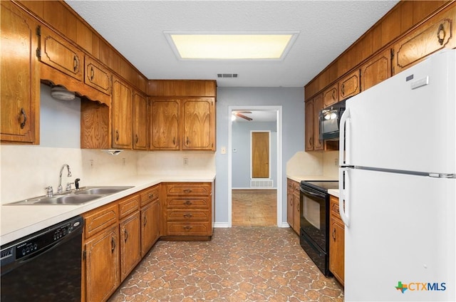 1606 Cedar Oaks Ln, Harker Heights, TX 76548 - kitchen with black appliances, brown cabinets, and light countertops