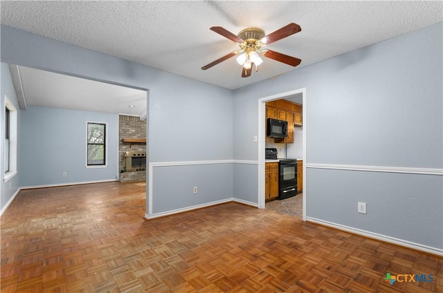 1606 Cedar Oaks Ln, Harker Heights, TX 76548 - spare room featuring a ceiling fan, a textured ceiling, and a fireplace