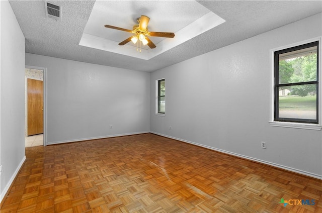 1606 Cedar Oaks Ln, Harker Heights, TX 76548 - spare room with a tray ceiling, a ceiling fan, and a textured ceiling